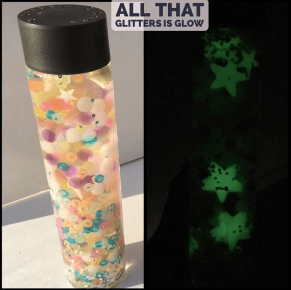 A sensory bottle filled with glow in the dark beads and stars