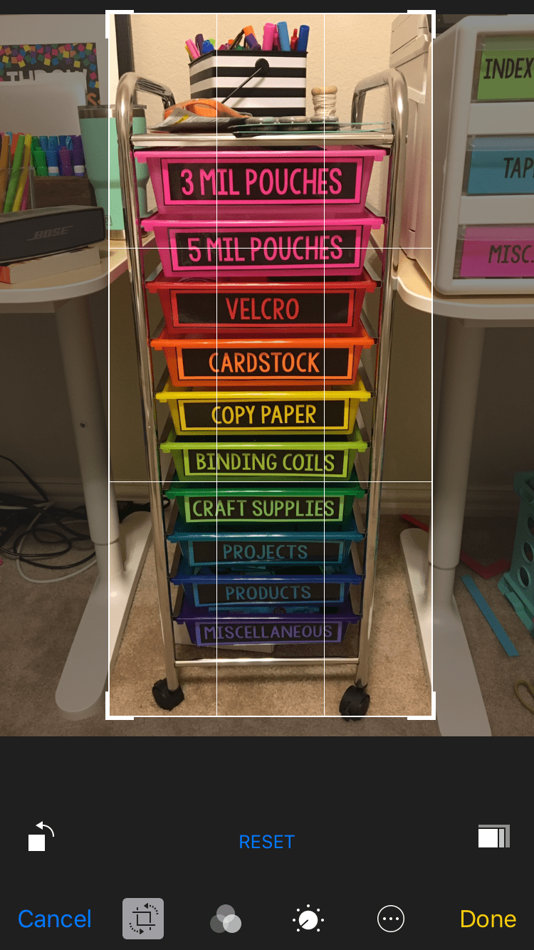 A cropped photo of a rolling portable rainbow colored set of drawers