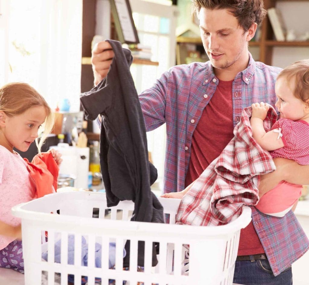 A father and his children sorting laundry