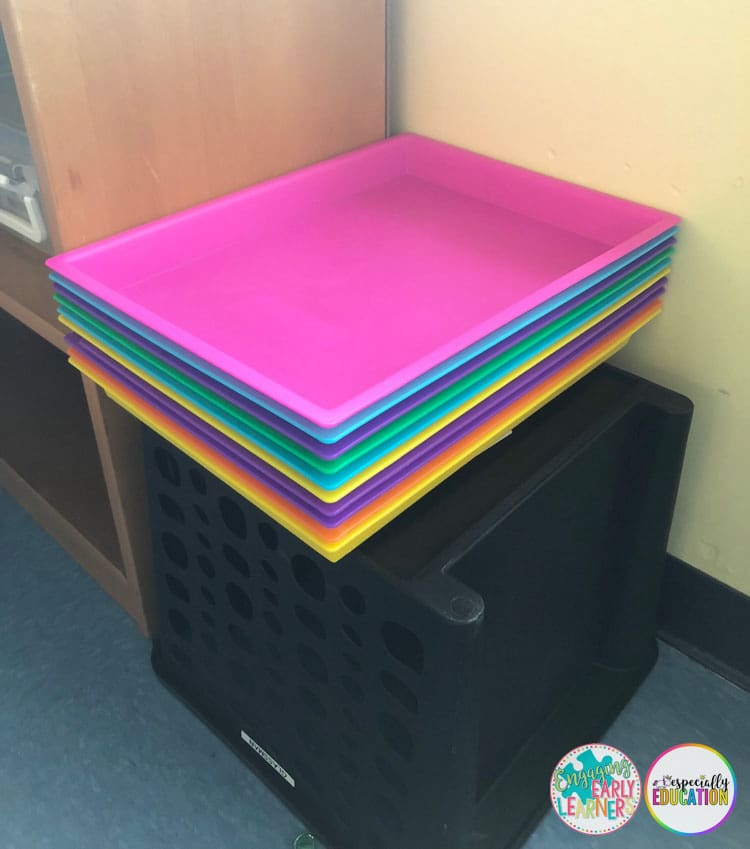 Colorful plastic boxes and drawers filled with Especially Education task box materials.
