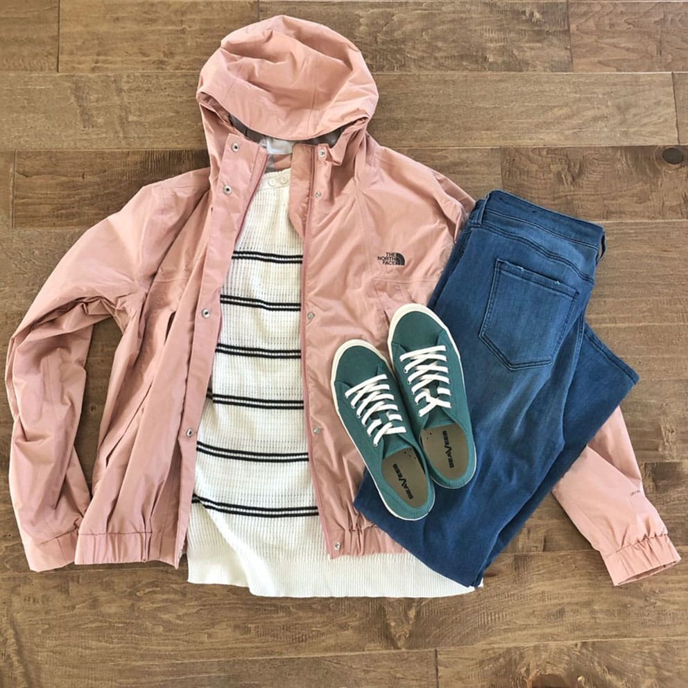 Pink windbreaker, blue jeans, striped sweater, and blue sneakers from Stitch Fix are perfect for busy teachers