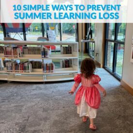 Little girl in a pink dress in the children's section at the local library
