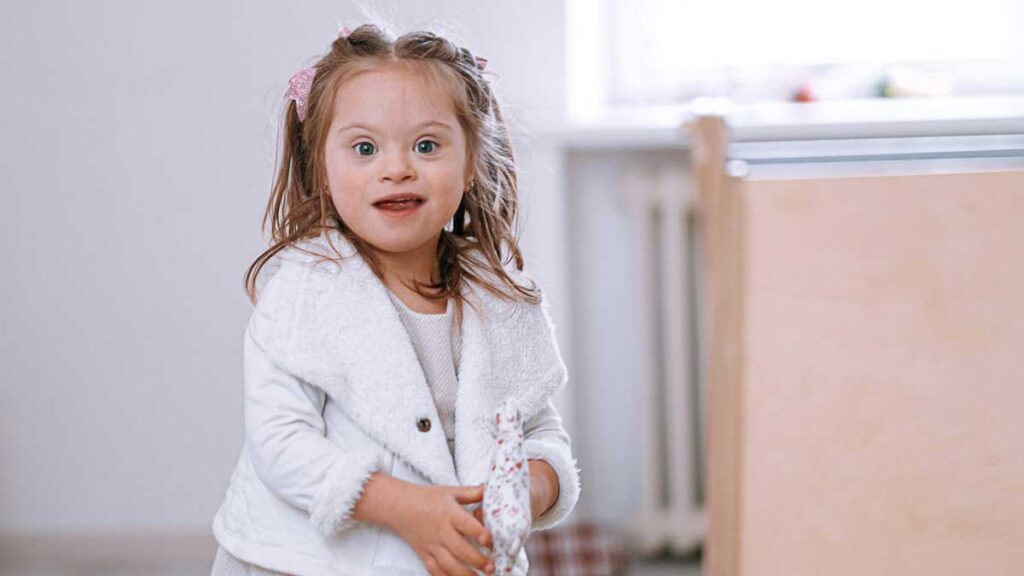 Young girl holding a wrapped handmade Mother’s Day gift created during a classroom activity in special education