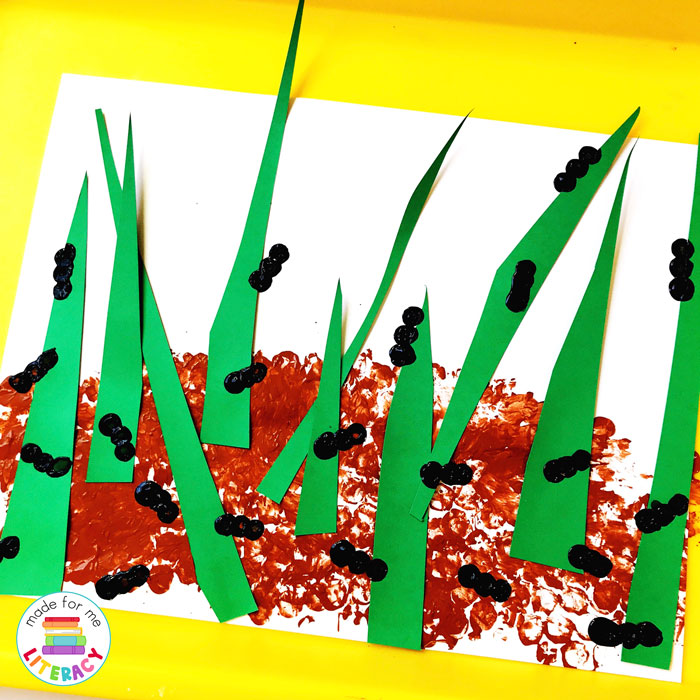 Ant in grass craft activity made with colored paper that builds fine motor skills through hands-on learning