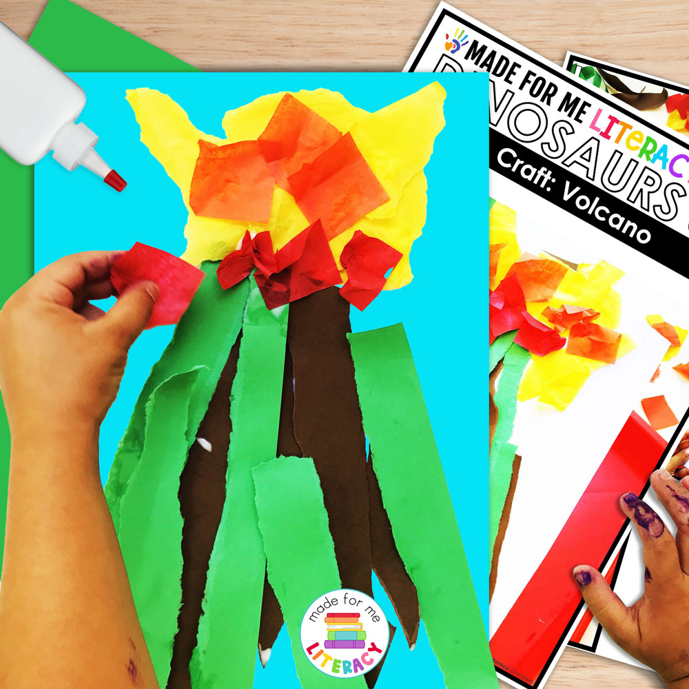 Student creating a volcano craft using torn paper and glue