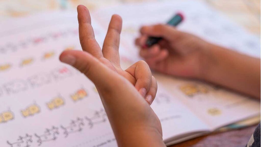 Young child using their fingers to help them learn math skills