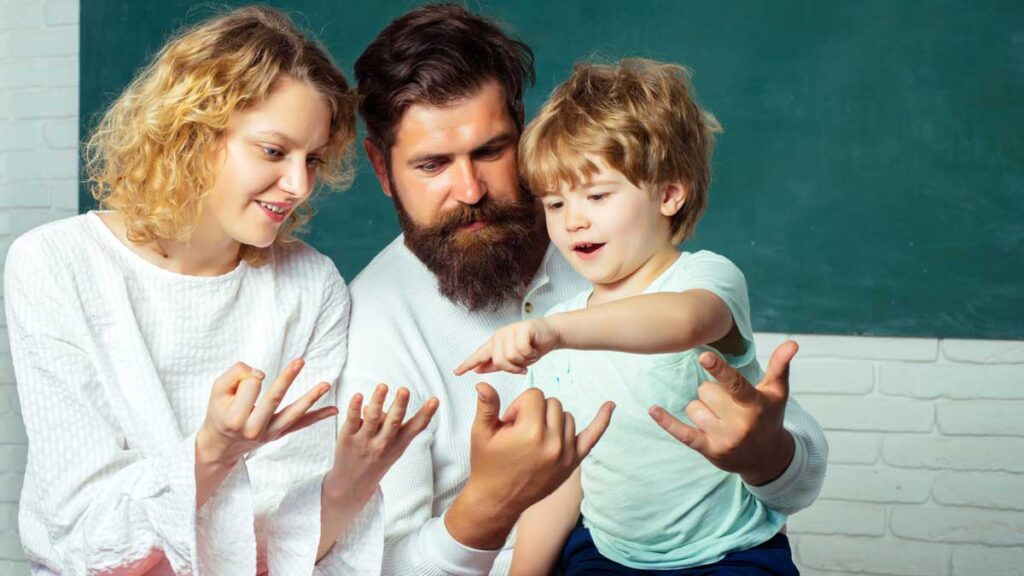 Two parents using their fingers for their preschool age son learn to count