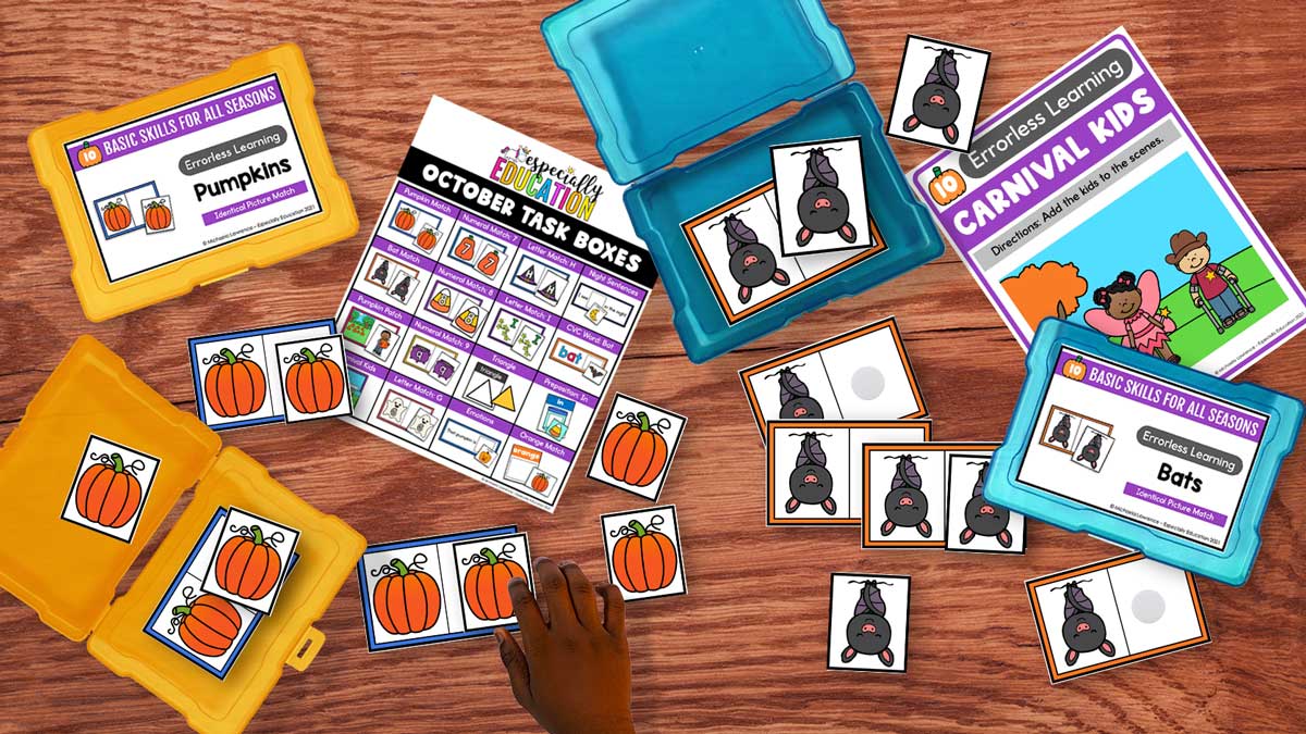 Fall errorless task boxes with pumpkin and bat picture-matching cards, an October activity overview, and a child’s hand near the pumpkin cards.